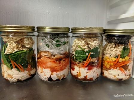 4 types of instant noodle jars in a fridge